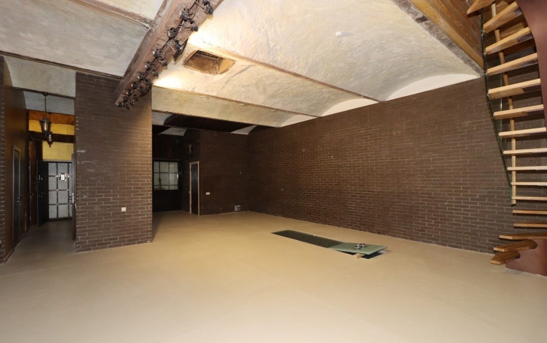 Spacious room with brick walls and arches
