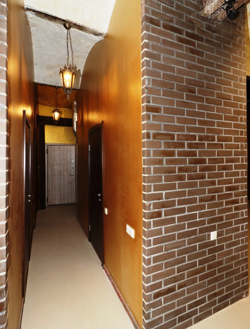 Corridor with brick walls and lights