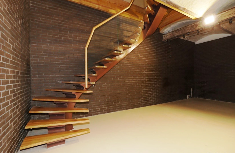 Modern wooden stairs with glass railing