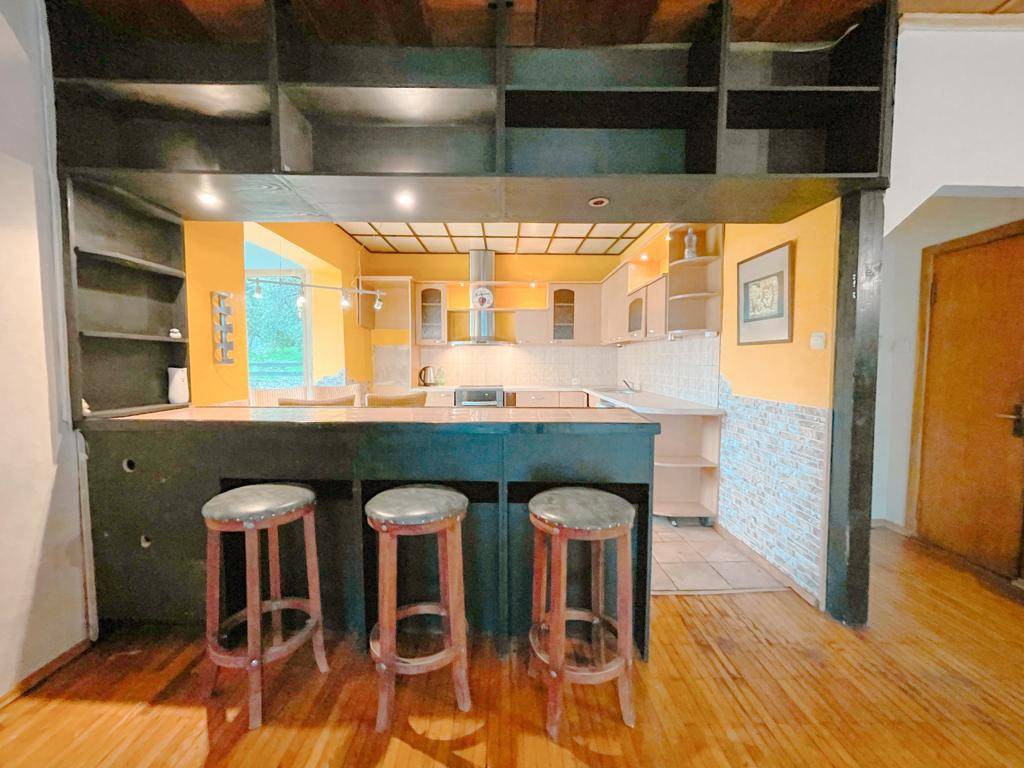 Kitchen with bar counter and stools