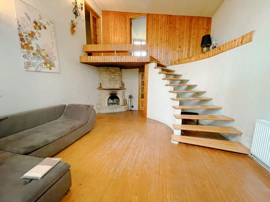 Living room with fireplace and stairs