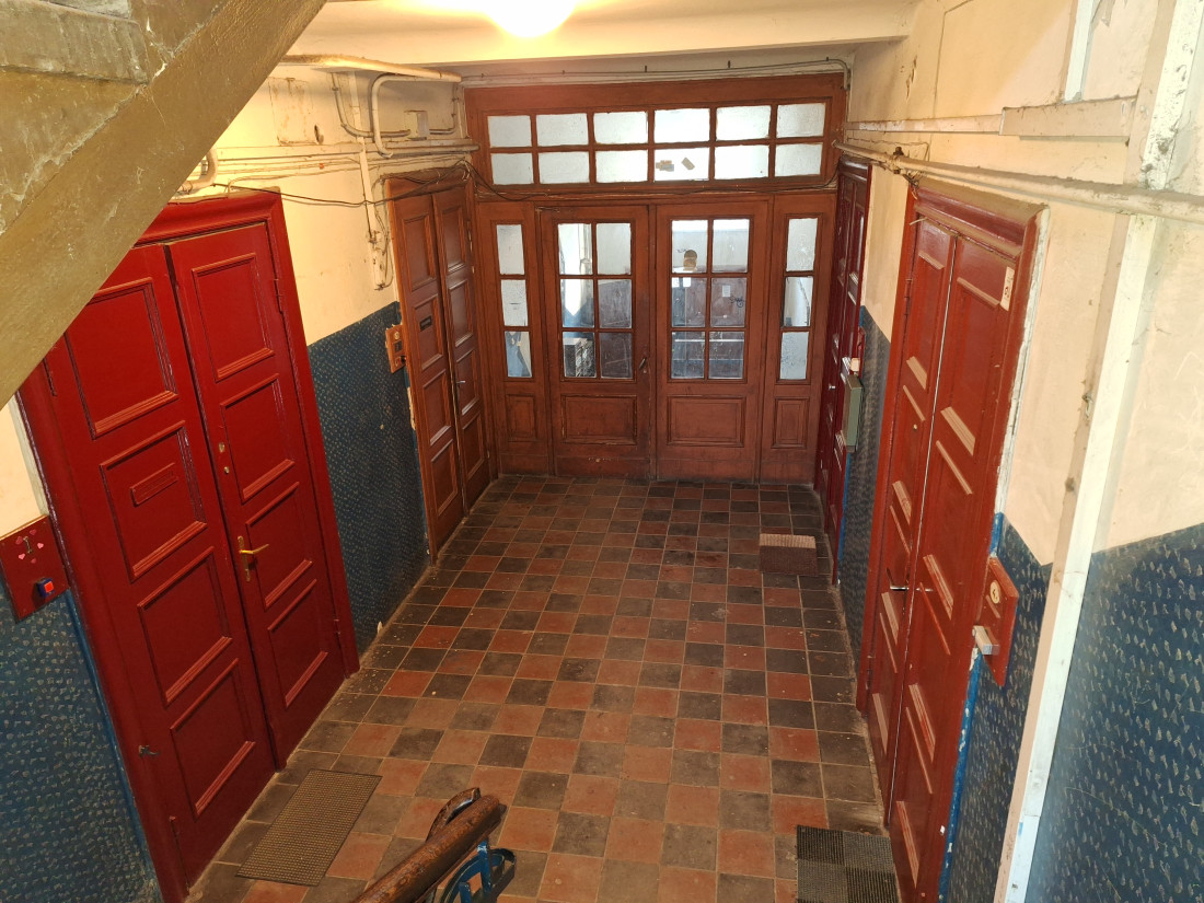 Staircase entrance with red doors.