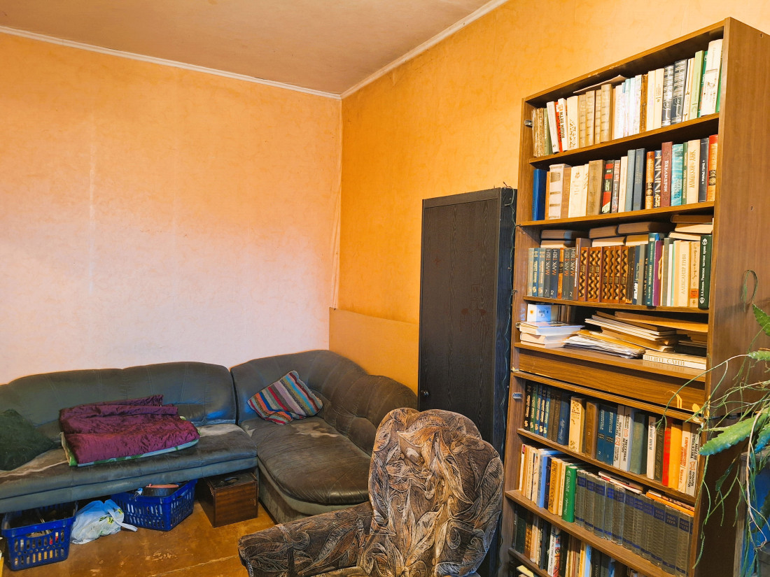 Room with shelves and book collection.