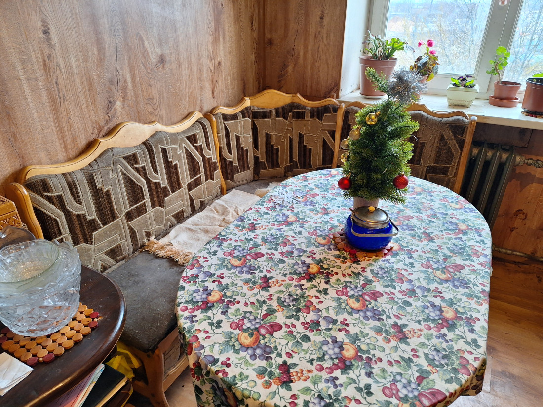 Kitchen corner with a table and couch.