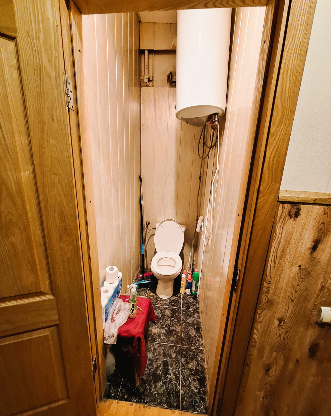 Small restroom with a boiler.