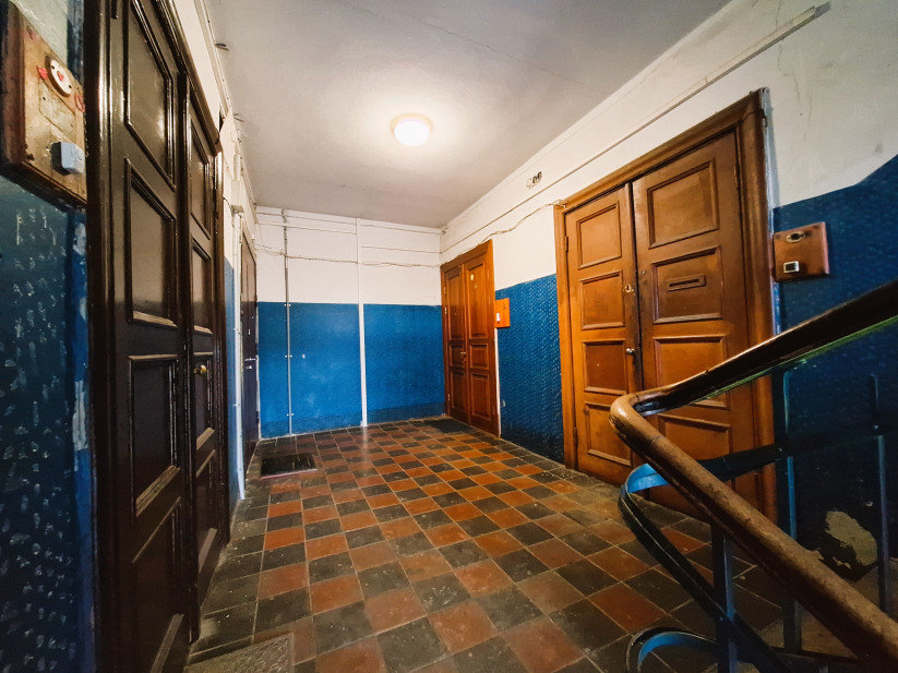 Stairwell with dark doors and tiles.