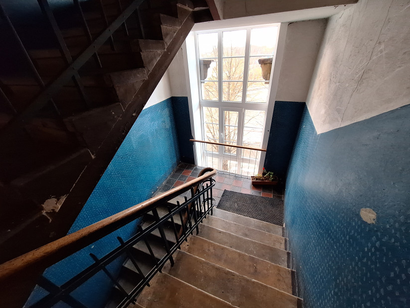 Staircase by a window overlooking the street.