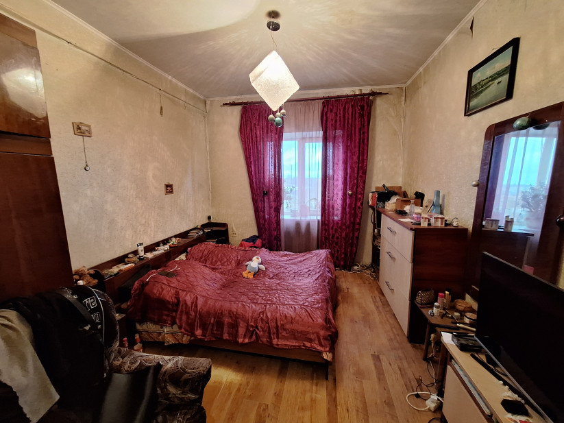 Bedroom with a large bed and curtains.