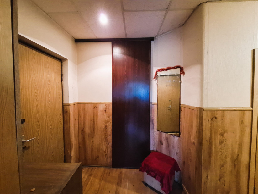 Bright hallway with wooden walls.