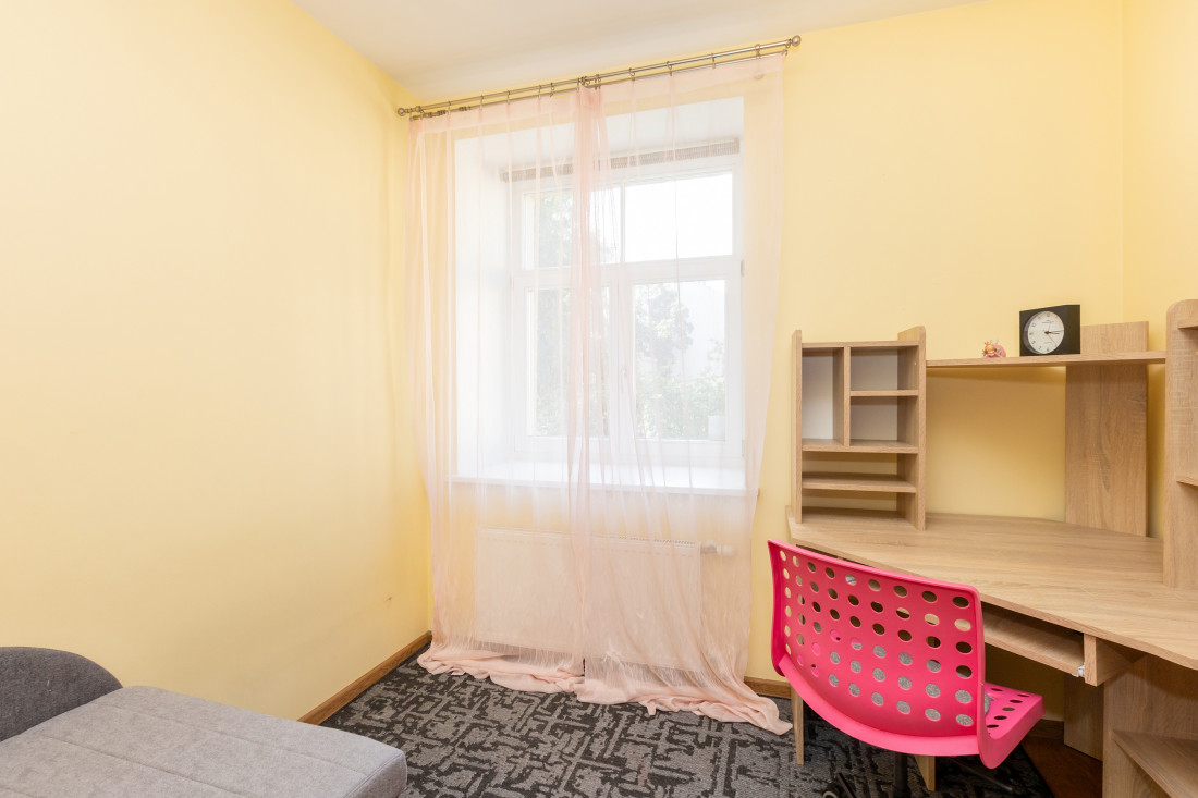 Window view with light curtains and desk.