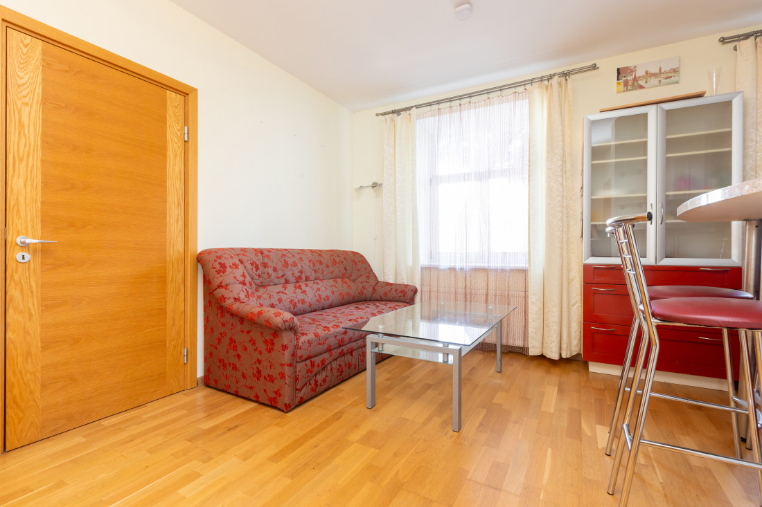 Living room with sofa and glass table.