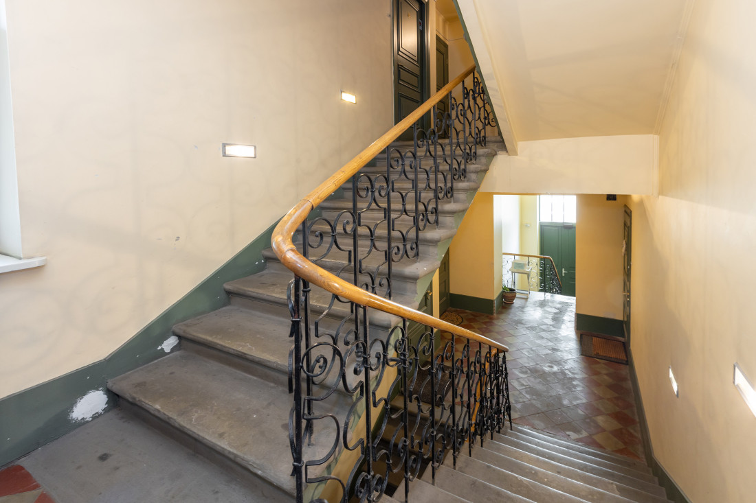 Staircase with wooden railings and doors.