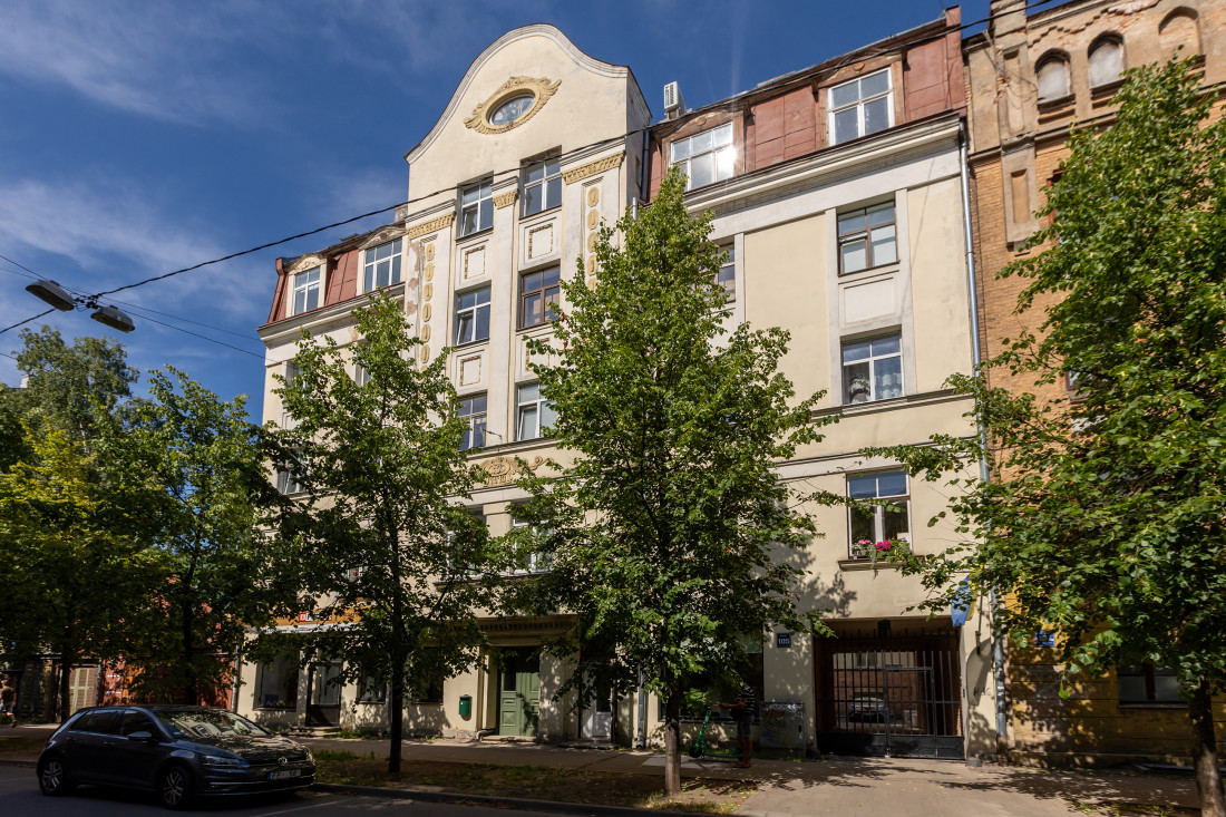 Apartment building facade with trees.