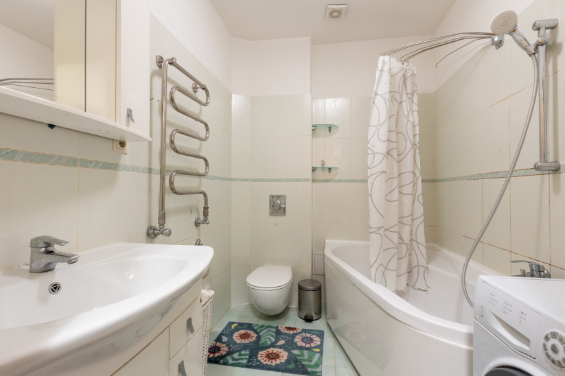 Bathroom with shower area and bathtub.