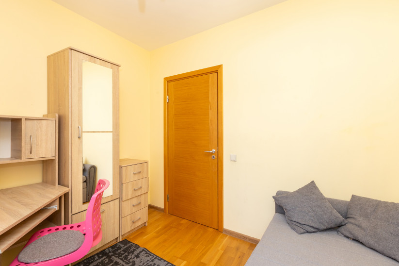Bedroom with wooden furniture and desk.