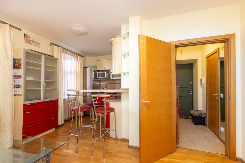 Apartment kitchen with bar counter area.