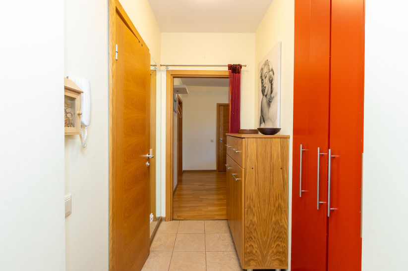 Hallway with a wardrobe and wall art.