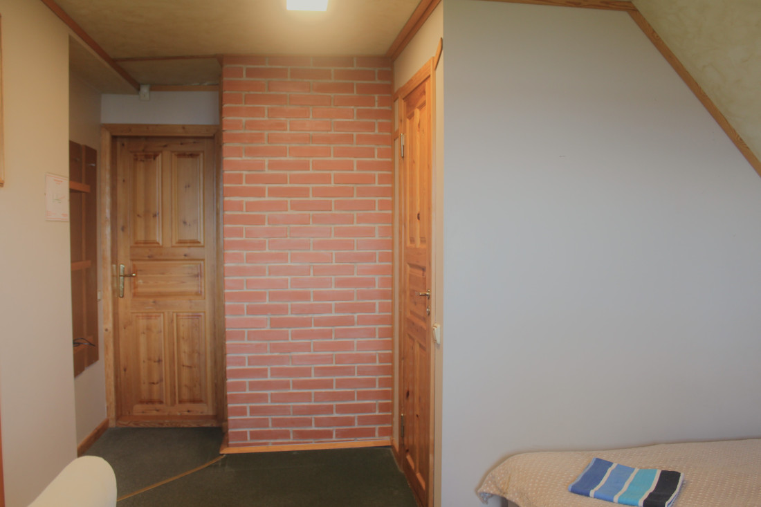 Hallway with brick and wood decor.