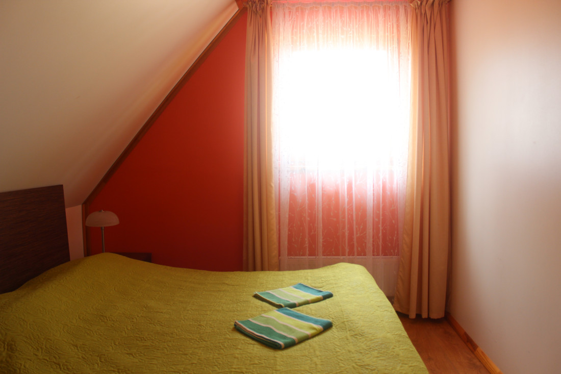 Bedroom with a bed and curtains.