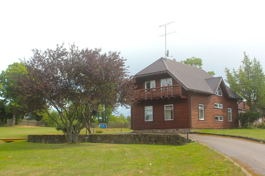 Wooden house with a garden and path.