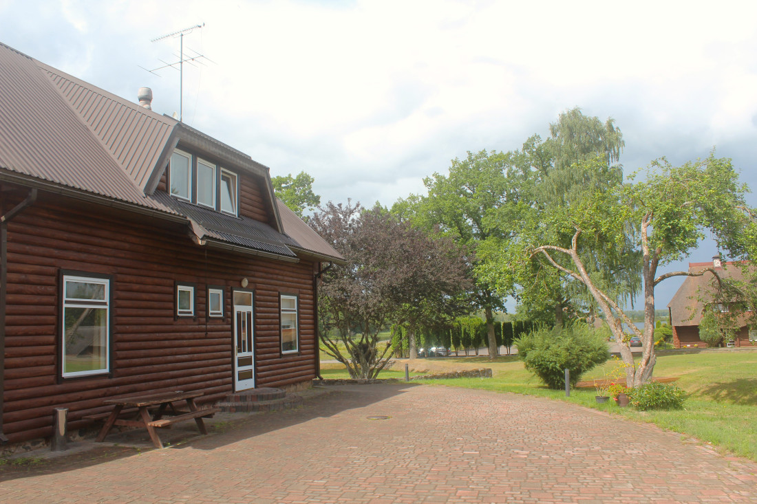 Small countryside house with trees.