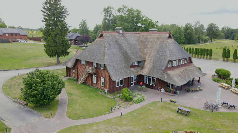 Traditional thatched-roof building in a leisure area