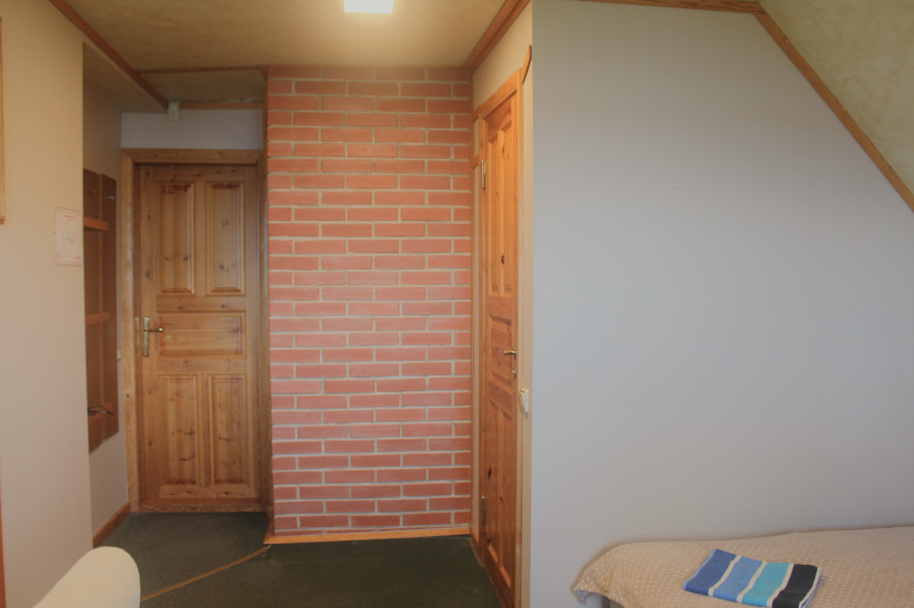 Hallway with brick and wood decor.