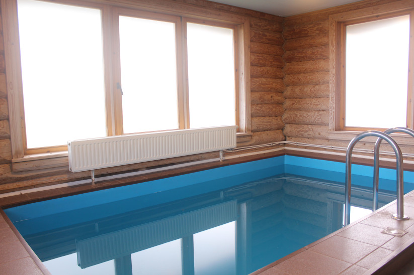 Pool with large windows and radiator.
