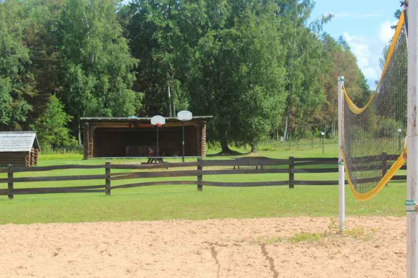 Beach volleyball court and wooden shed.