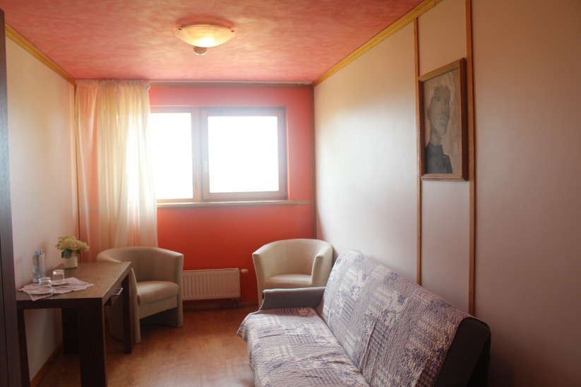 Room with bright lighting and windows.