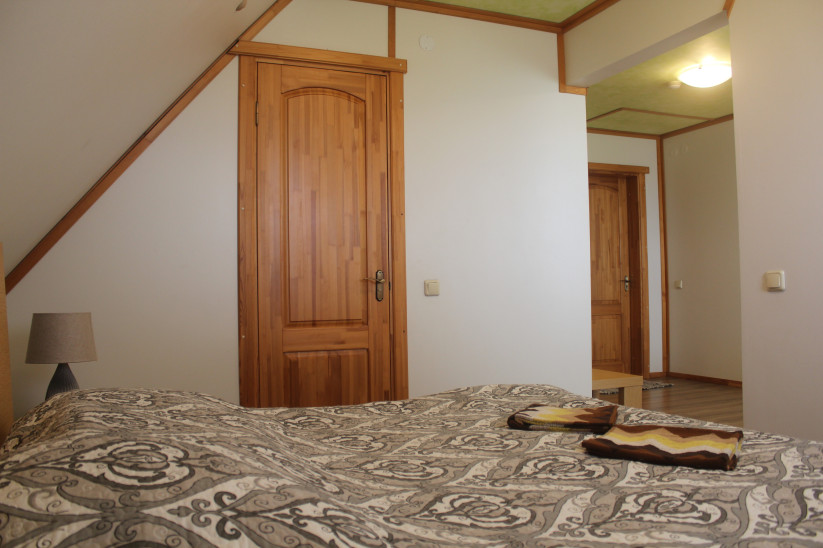 Double bed with wooden door background