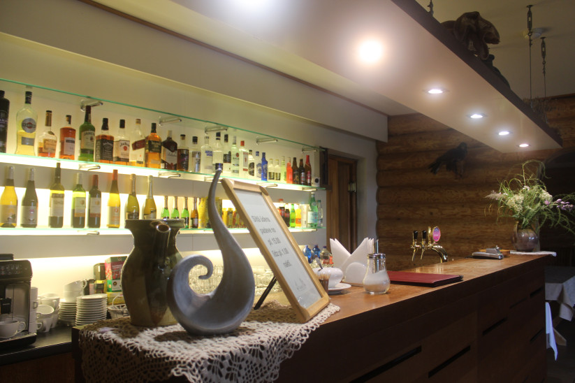 Bar with drinks and wooden finish.