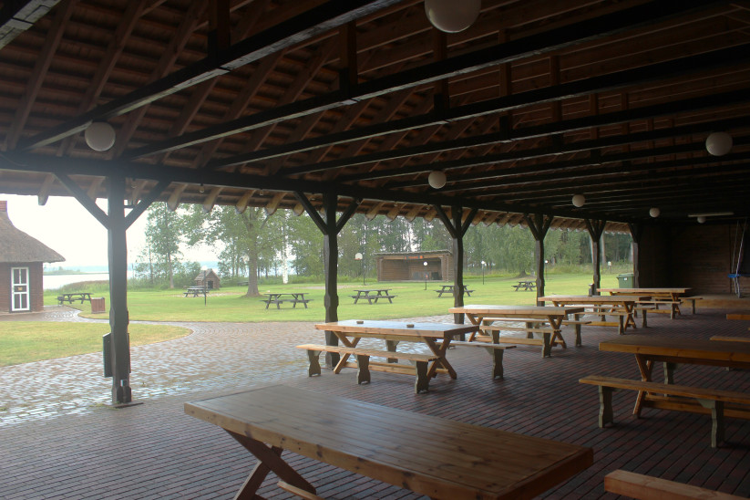 Large wooden shelter with tables.