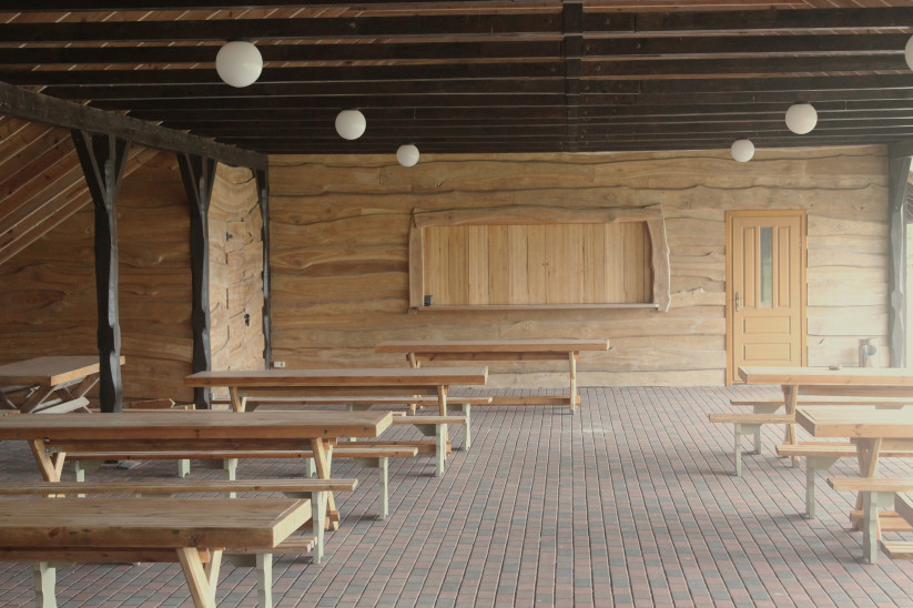 Spacious shelter with wooden walls.