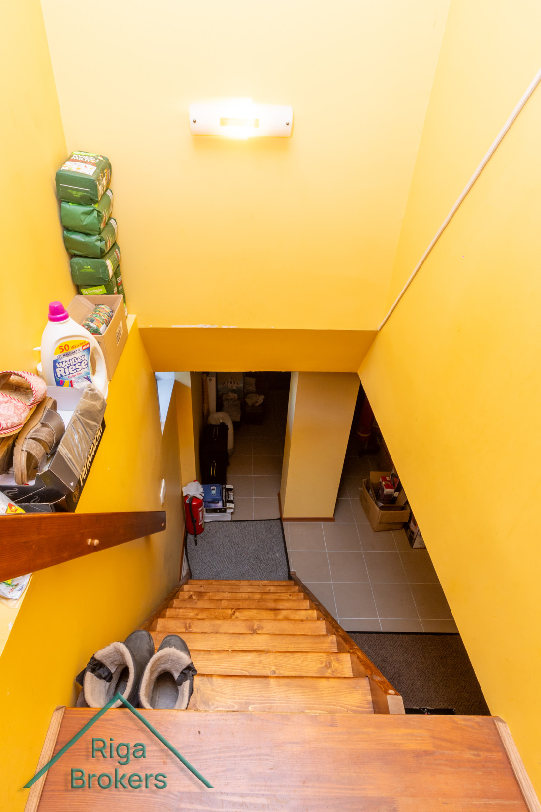 Staircase view from above, yellow walls.