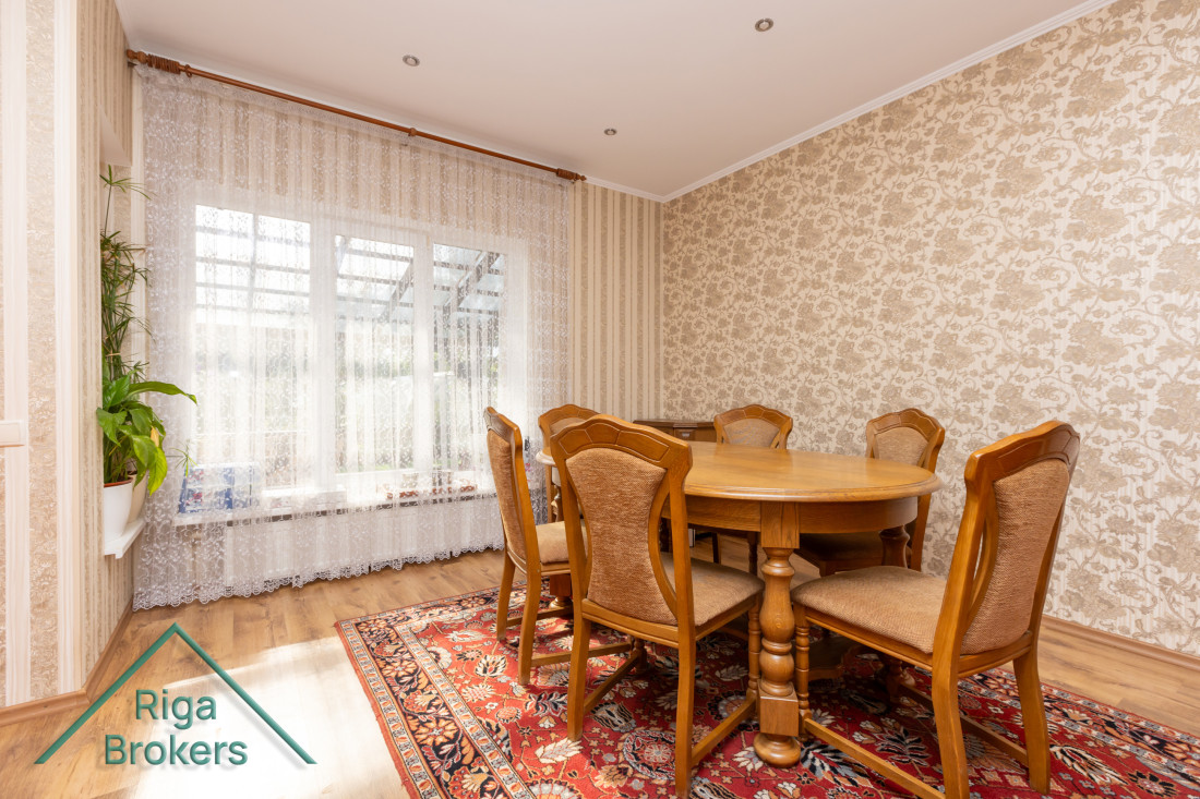 Dining room with wooden table and chairs.
