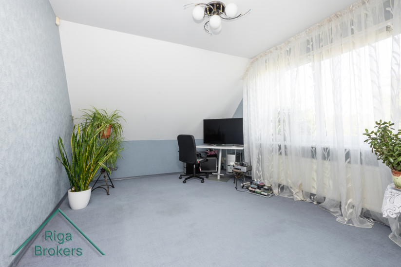 Home office with window and equipment.