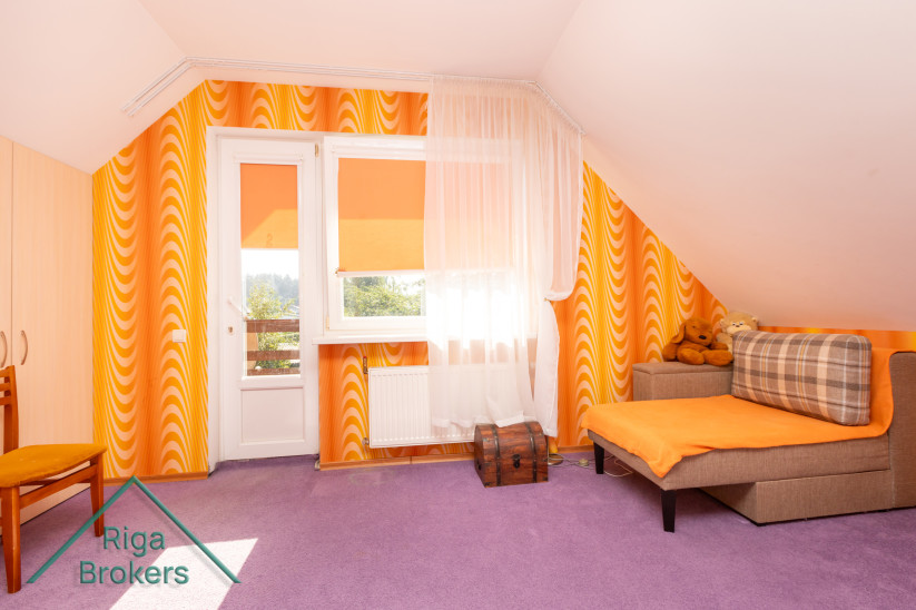 Kids' room with a balcony and bed.