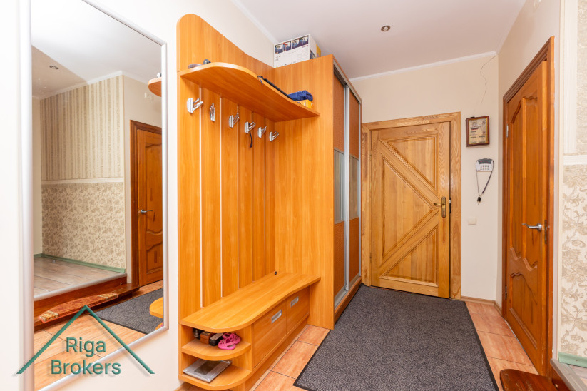Entryway furniture and wooden door.