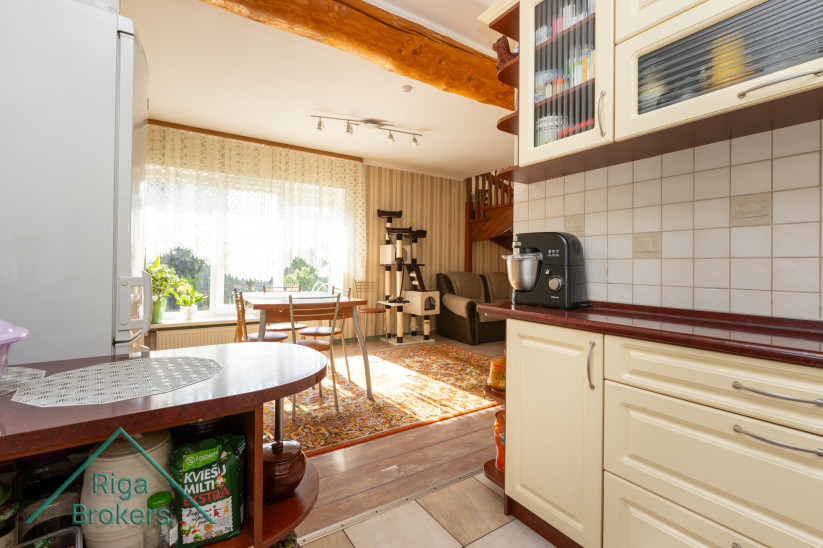 Kitchen and living room with large windows.