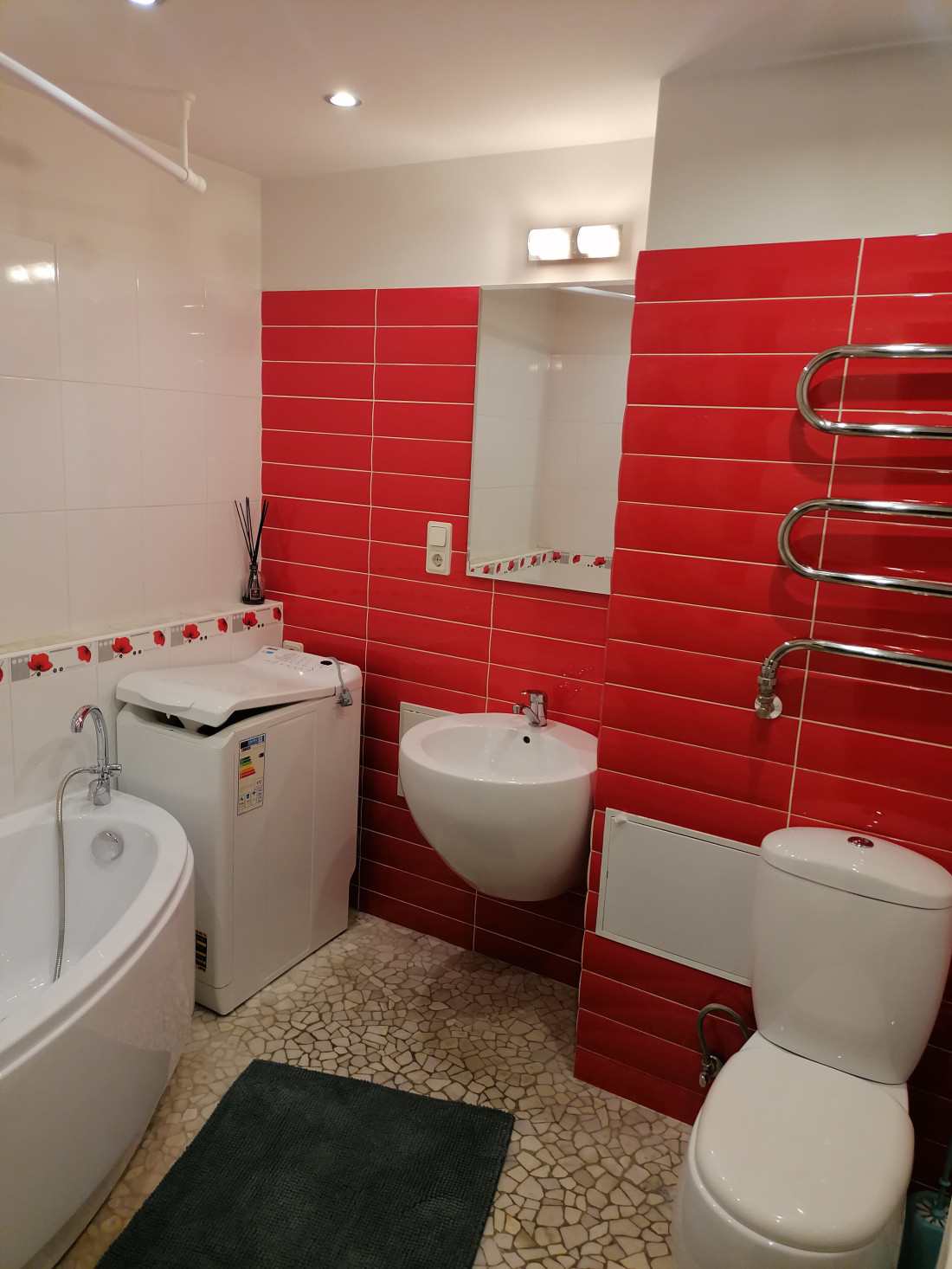 Bathroom with red tiled walls.