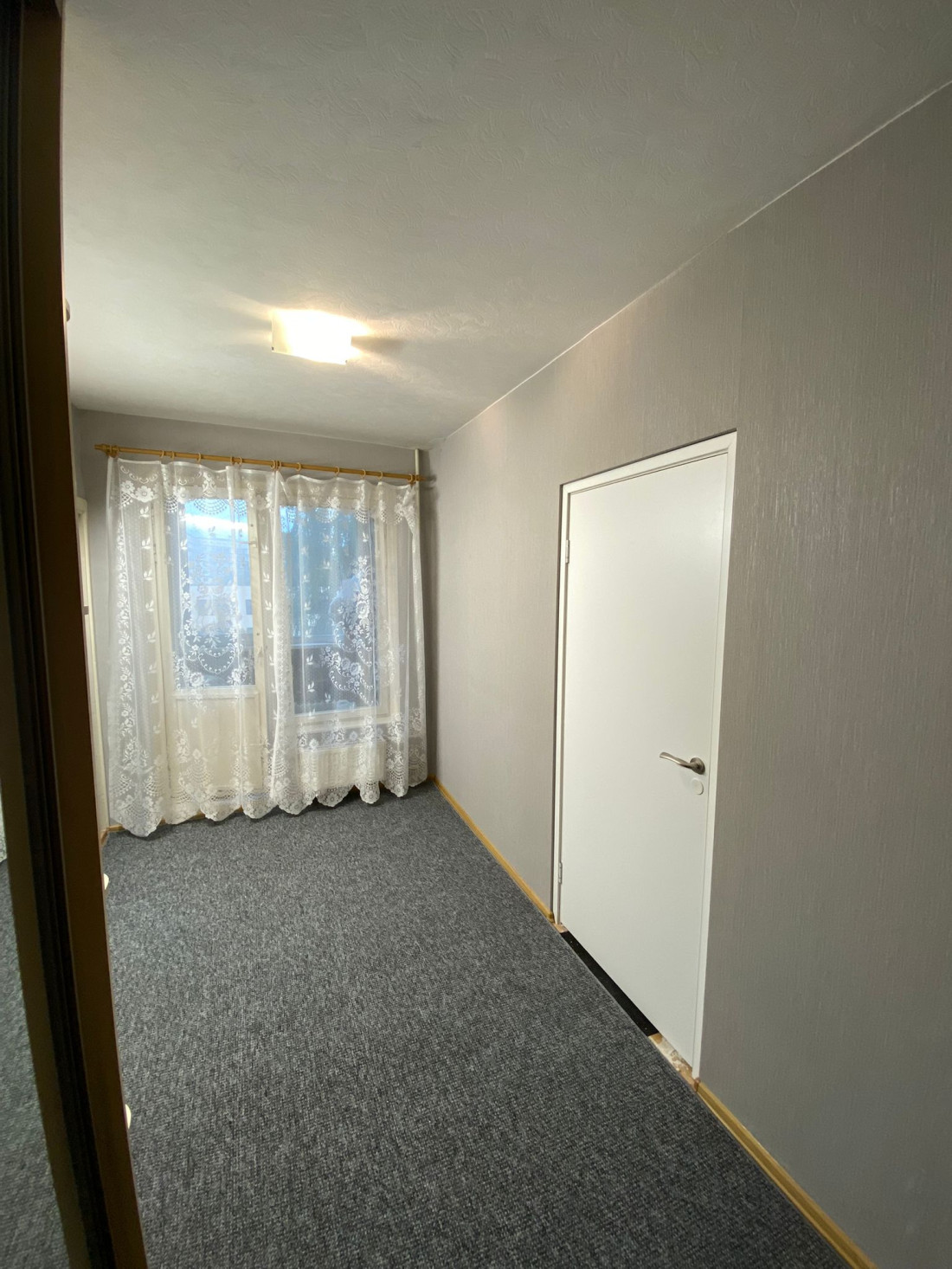 Hallway with doors and windows.