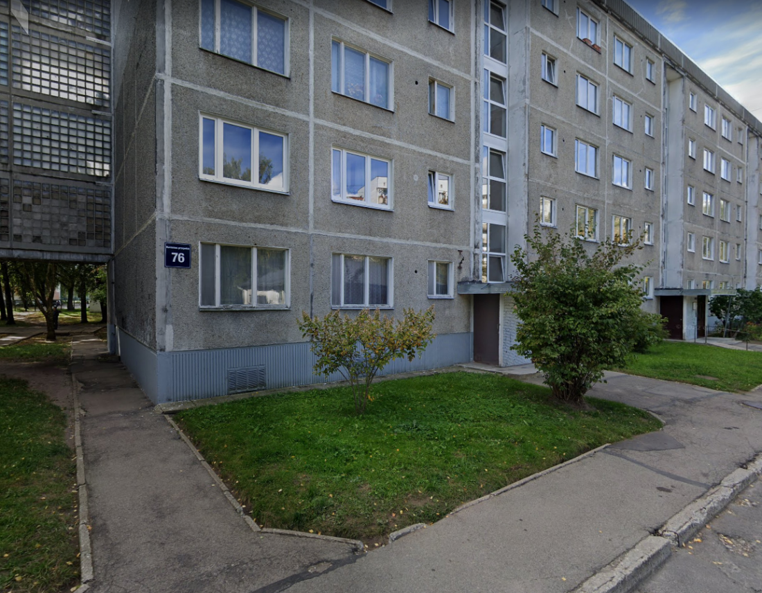 Apartment building with green lawn.