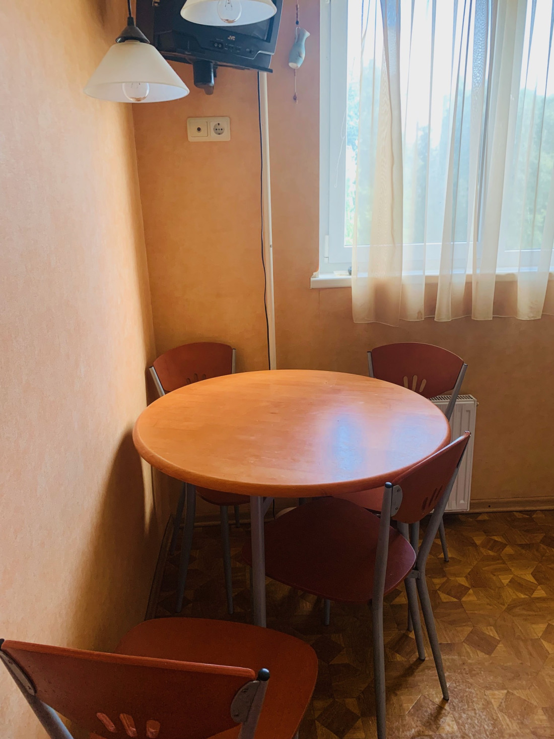Kitchen with round table and window.