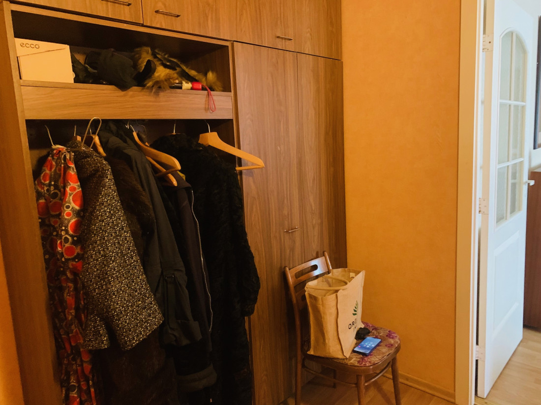 Corridor with wardrobes and a chair.