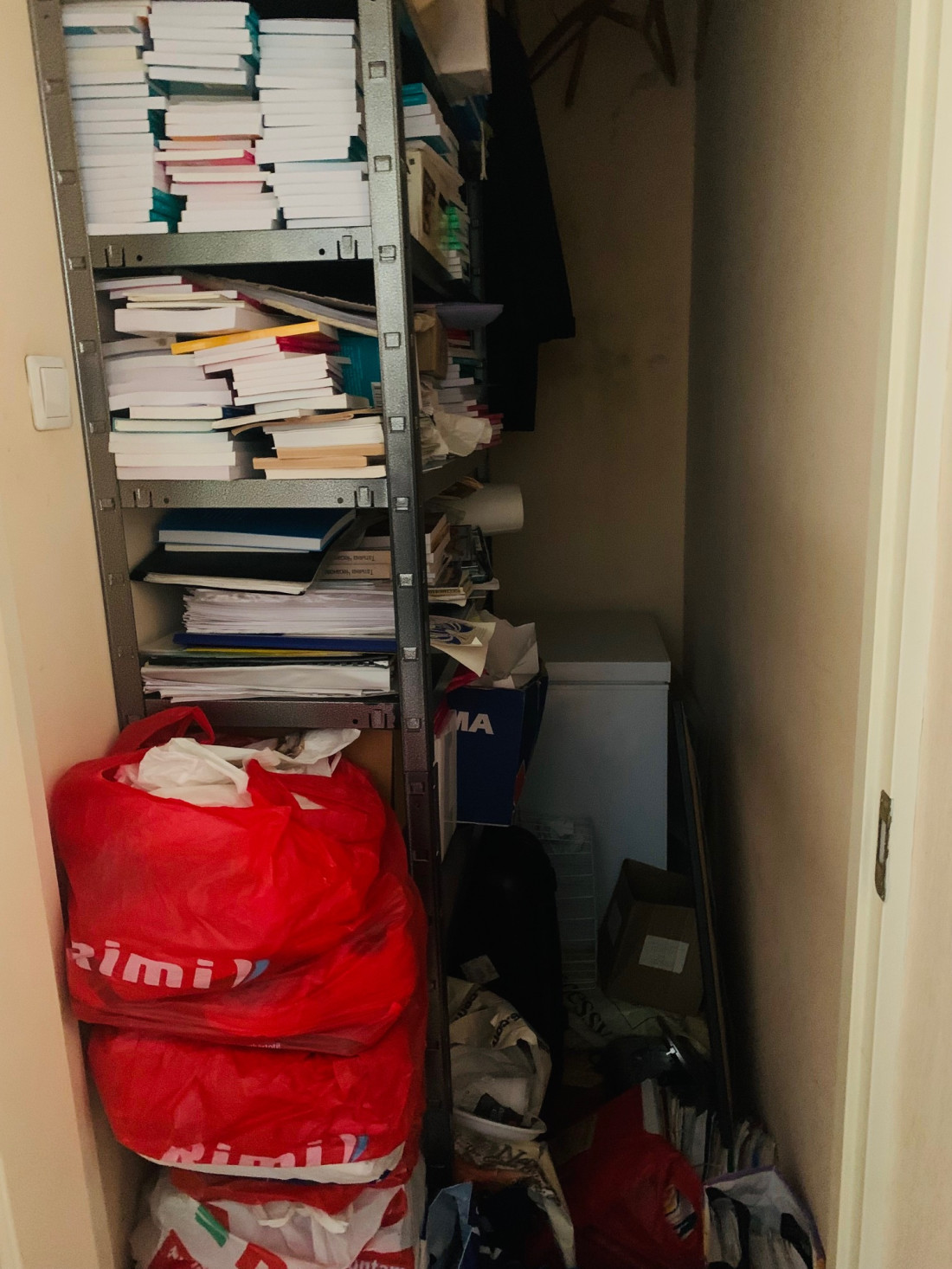 Storage room with shelves and bags.