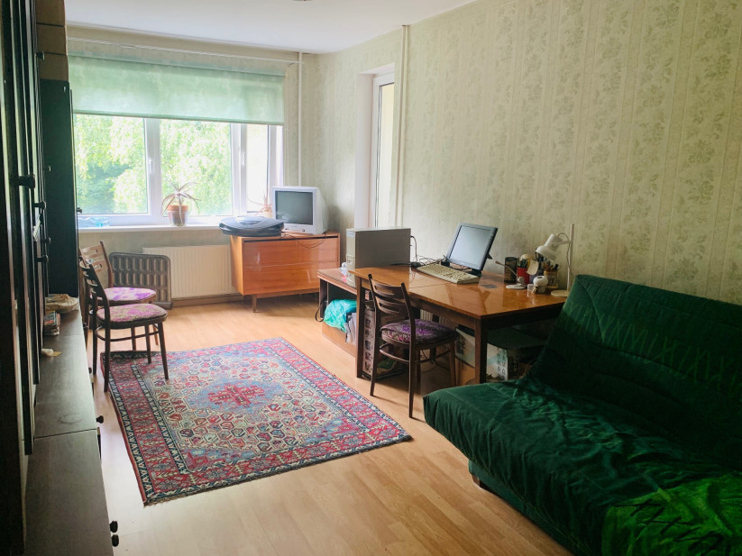 Room with computer desk and sofa.