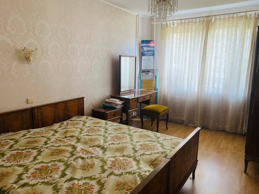 Bedroom with decorative bed and curtains.