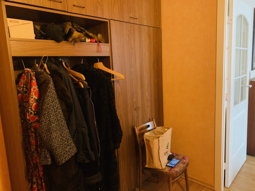 Corridor with wardrobes and a chair.