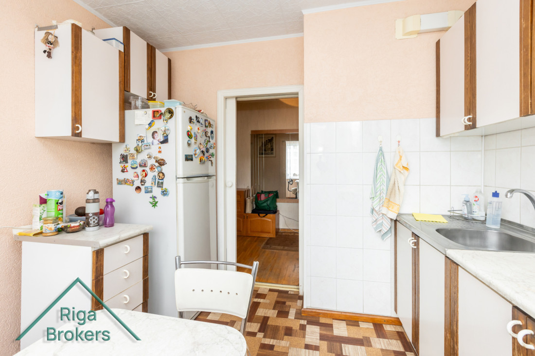 Kitchen with dining table and fridge.
